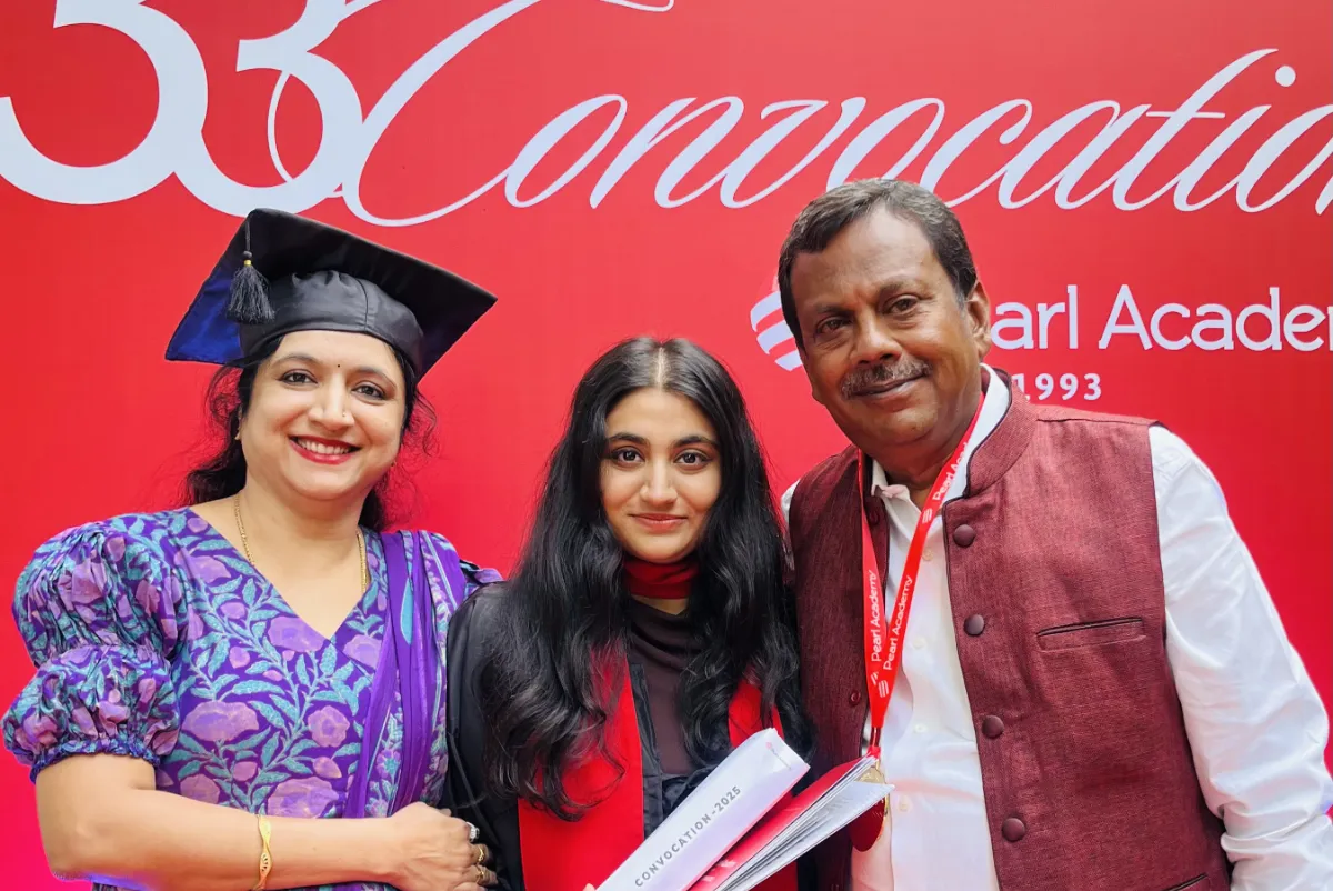 Nanditha in her graduation gown with two faculty members at the 33rd convocation.